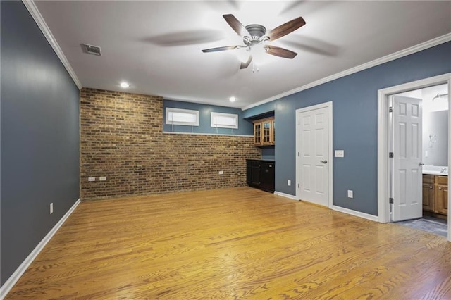 1605 Pavillion Ridge Dr SE, Smyrna, GA 30080 - unfurnished living room with brick wall, a ceiling fan, light wood-type flooring, and crown molding