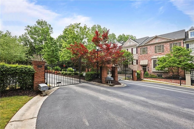 1605 Pavillion Ridge Dr SE, Smyrna, GA 30080 - view of asphalt road with a gated entry, a gate, and curbs