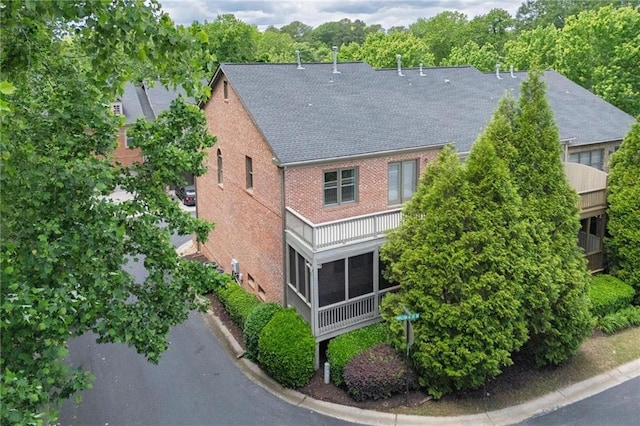 1605 Pavillion Ridge Dr SE, Smyrna, GA 30080 - exterior space with a sunroom, brick siding, and roof with shingles