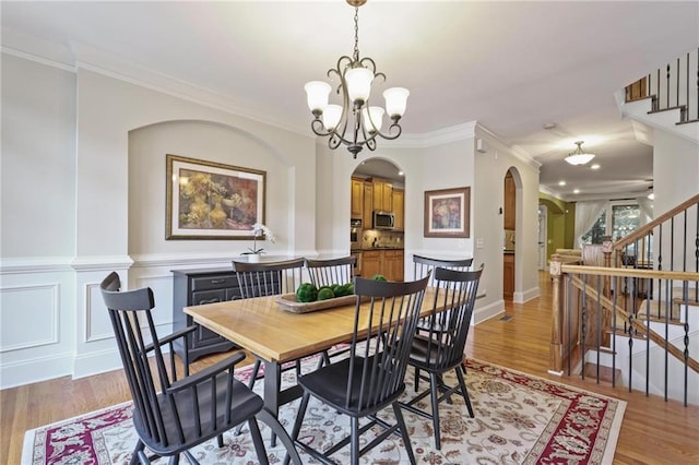 1605 Pavillion Ridge Dr SE, Smyrna, GA 30080 - dining space with arched walkways, stairway, light wood-type flooring, and ornamental molding