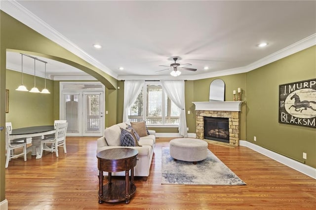 1605 Pavillion Ridge Dr SE, Smyrna, GA 30080 - living area with ornamental molding, wood finished floors, a ceiling fan, a fireplace, and recessed lighting