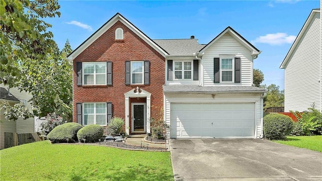 view of front of property with a garage and a front lawn