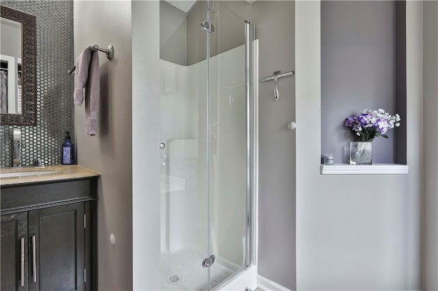 bathroom featuring vanity and a shower with door