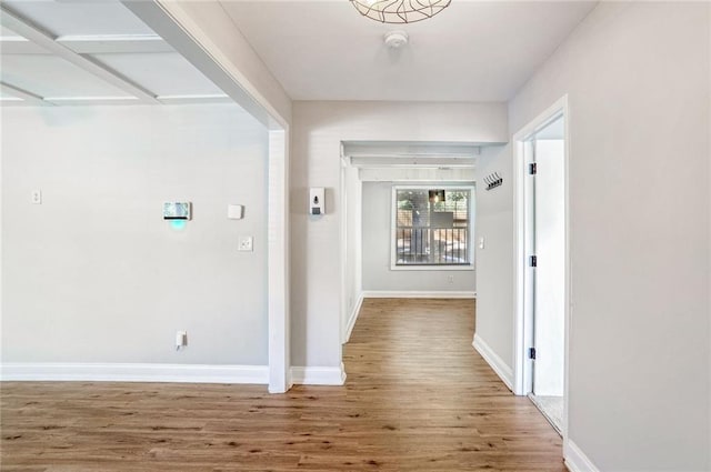 hallway with hardwood / wood-style flooring