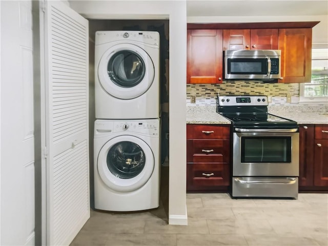 laundry area with stacked washing maching and dryer and laundry area