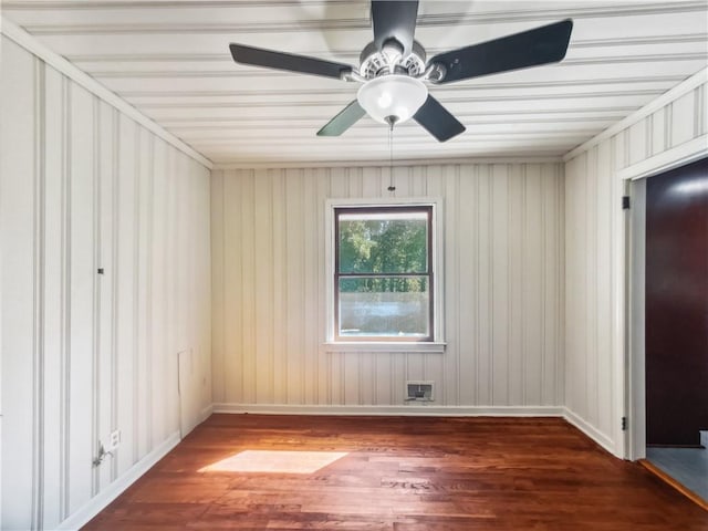 empty room with baseboards, a ceiling fan, and wood finished floors