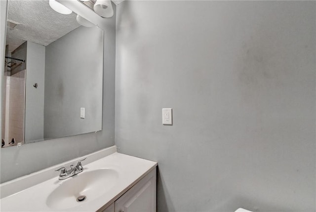 bathroom featuring vanity and a textured ceiling