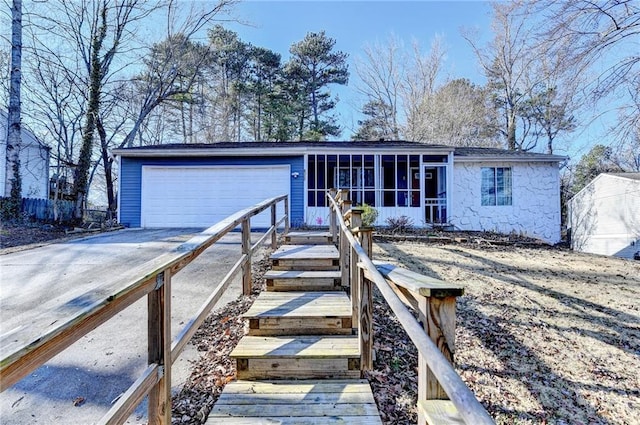 single story home with a garage and a sunroom