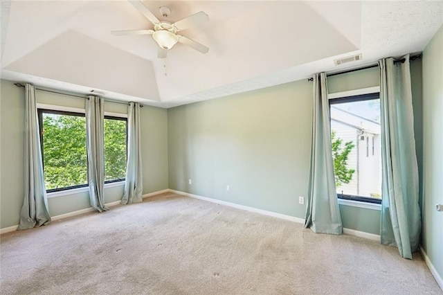 spare room with carpet floors, a ceiling fan, baseboards, and visible vents