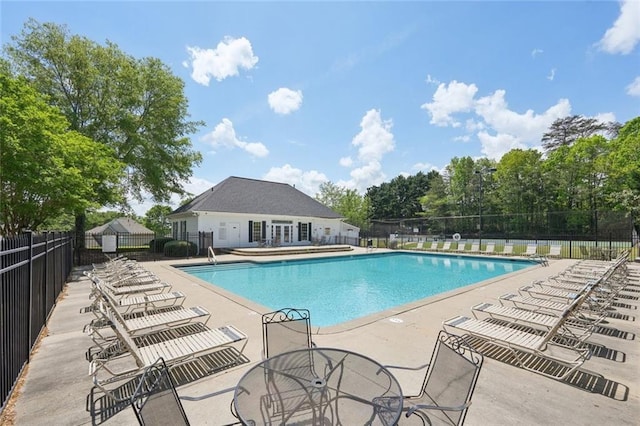 pool featuring fence and a patio area