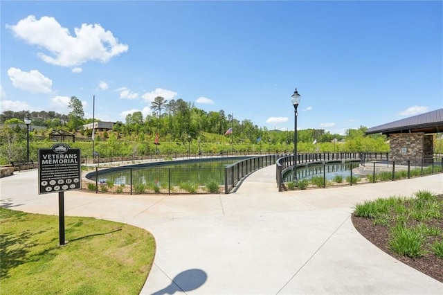 view of community featuring fence
