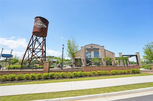 view of home's community featuring fence