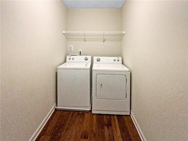 laundry area with washer and clothes dryer and dark hardwood / wood-style flooring