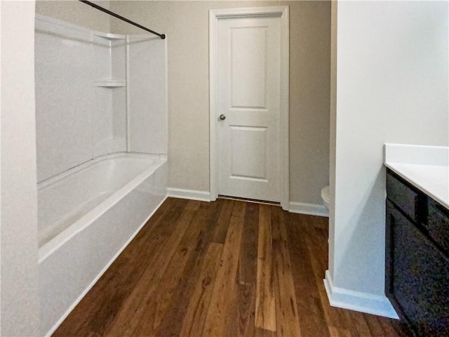 full bathroom featuring vanity, toilet, wood-type flooring, and bathtub / shower combination