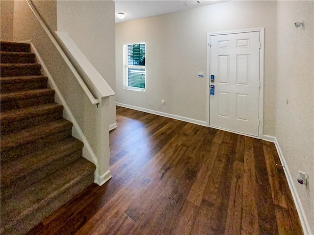 entryway with dark hardwood / wood-style floors