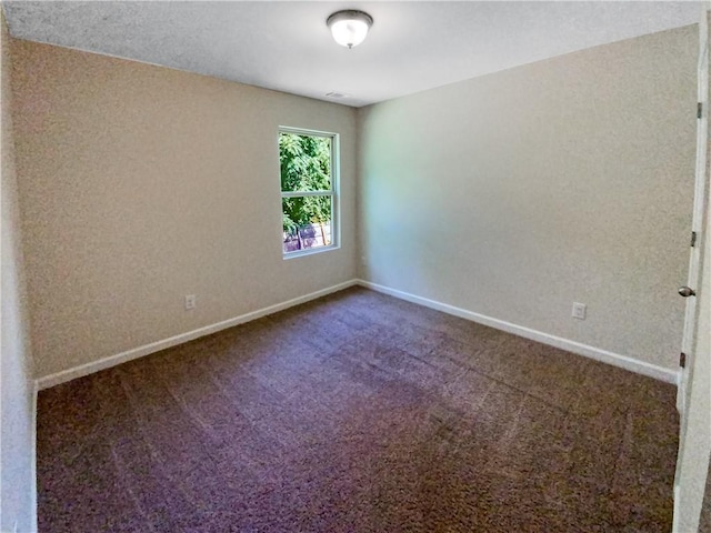 unfurnished room featuring carpet