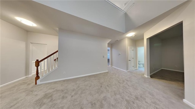 carpeted empty room featuring lofted ceiling