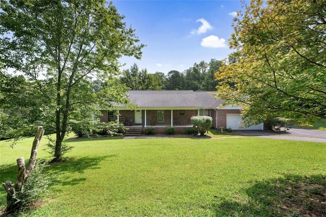 ranch-style home featuring a front lawn, driveway, covered porch, a garage, and brick siding