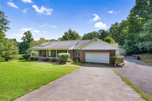 ranch-style house with aphalt driveway, a porch, brick siding, a front yard, and a garage
