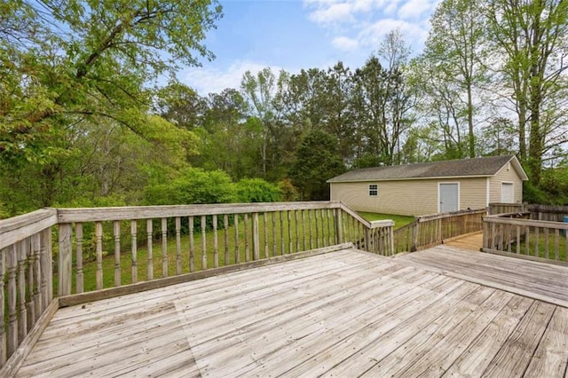 deck with a lawn and an outbuilding