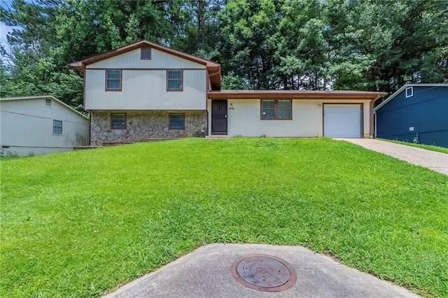 2247 Cherokee Valley Dr, Lithonia, GA 30058 - split level home featuring stone siding, driveway, an attached garage, and a front lawn