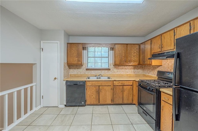 2247 Cherokee Valley Dr, Lithonia, GA 30058 - kitchen featuring black appliances, light countertops, brown cabinets, tasteful backsplash, and under cabinet range hood
