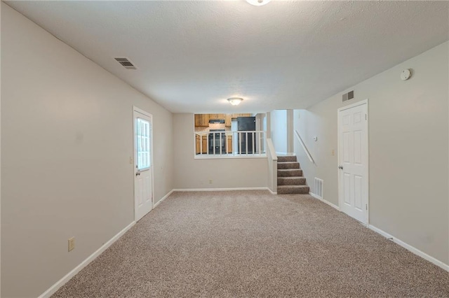2247 Cherokee Valley Dr, Lithonia, GA 30058 - unfurnished room with stairway, a smoke detector, and light colored carpet