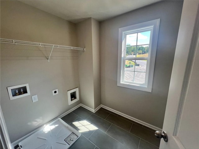 laundry area featuring hookup for a washing machine, dark tile patterned floors, and hookup for an electric dryer