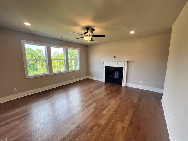 unfurnished living room featuring dark hardwood / wood-style flooring and ceiling fan