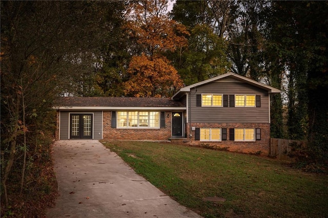 split level home with a front yard and french doors