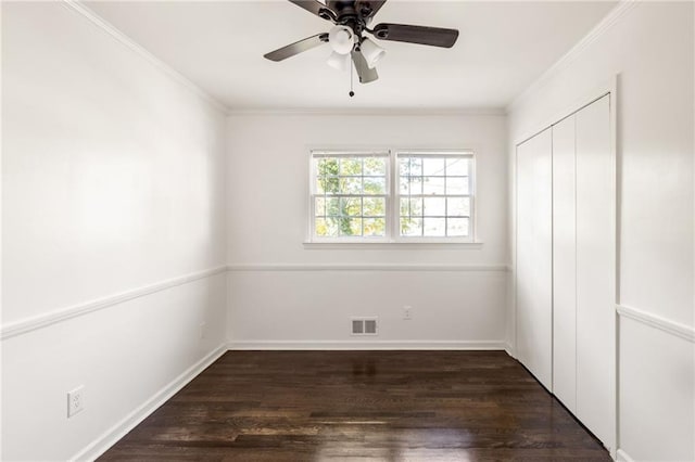 unfurnished bedroom featuring ornamental molding, dark hardwood / wood-style floors, ceiling fan, and a closet