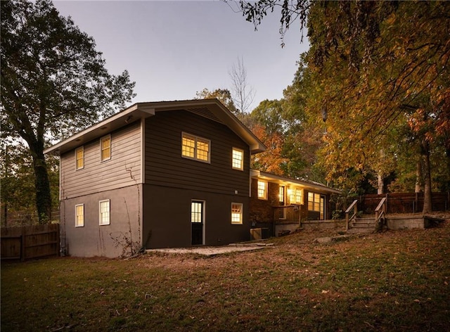 property exterior at dusk with a yard