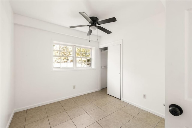 spare room featuring light tile patterned floors and ceiling fan