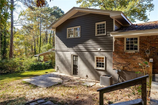 back of property featuring a patio and central air condition unit