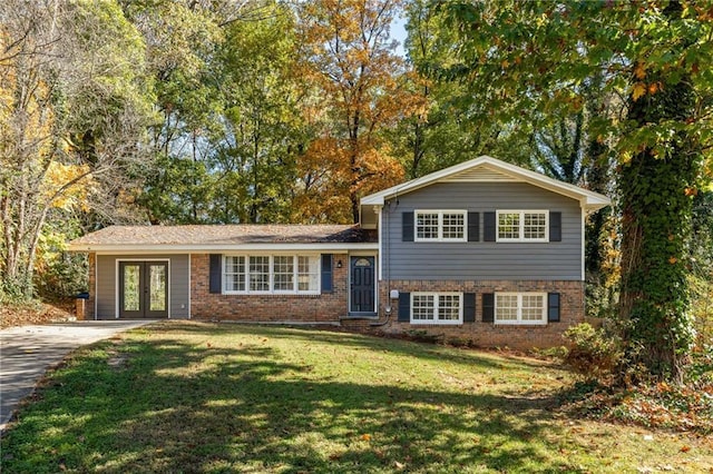 tri-level home featuring a front yard and french doors