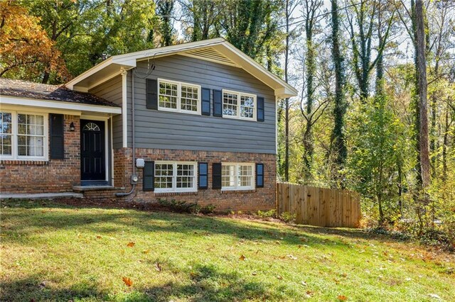 tri-level home featuring french doors and a front yard