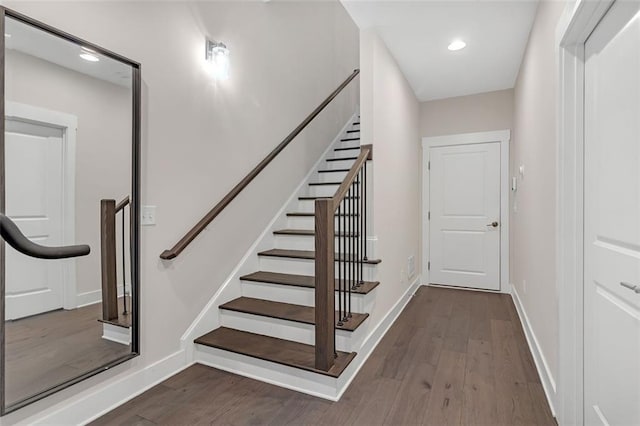 stairway featuring wood-type flooring