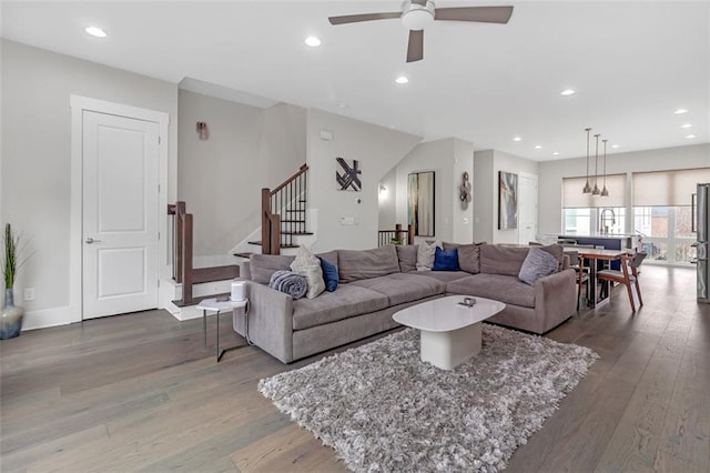 living room featuring ceiling fan, dark hardwood / wood-style flooring, and sink