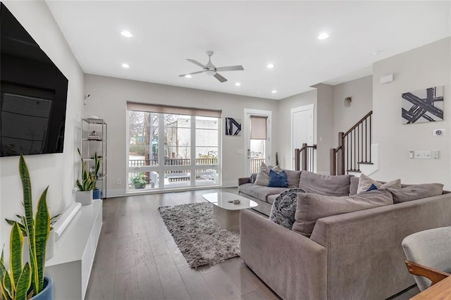 living room featuring ceiling fan and hardwood / wood-style flooring