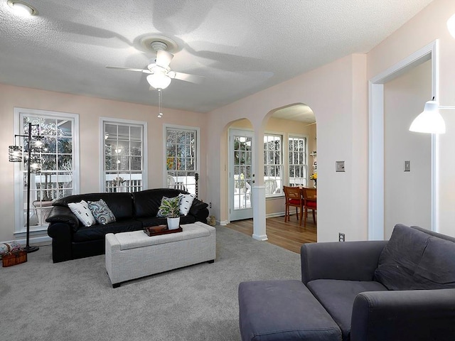 4601 Gann Xing SW, Smyrna, GA 30082 - living area featuring arched walkways, a ceiling fan, carpet floors, and a textured ceiling