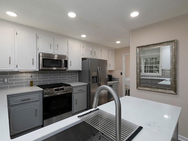 4601 Gann Xing SW, Smyrna, GA 30082 - kitchen with stainless steel appliances, white cabinets, tasteful backsplash, gray cabinets, and recessed lighting