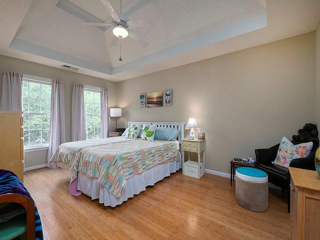 4601 Gann Xing SW, Smyrna, GA 30082 - bedroom with a raised ceiling, a textured ceiling, light wood finished floors, and a ceiling fan