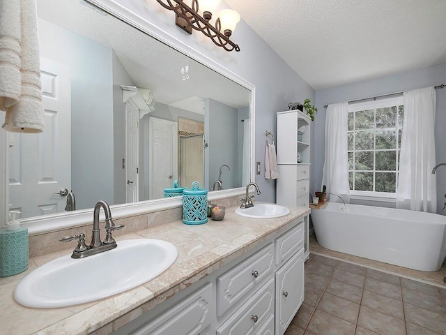 4601 Gann Xing SW, Smyrna, GA 30082 - bathroom with double vanity, a freestanding bath, tile patterned flooring, a stall shower, and a textured ceiling