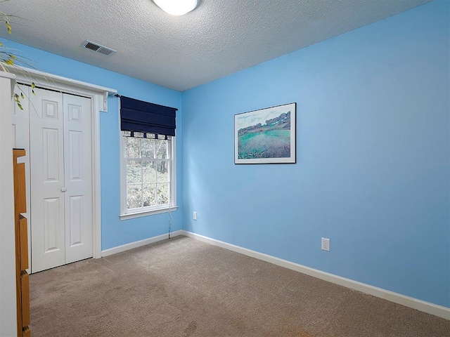 4601 Gann Xing SW, Smyrna, GA 30082 - unfurnished bedroom featuring carpet, a textured ceiling, and a closet