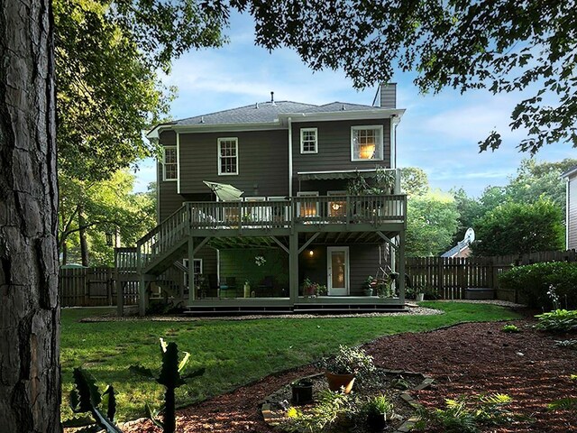 4601 Gann Xing SW, Smyrna, GA 30082 - back of property with a deck, a fenced backyard, a chimney, and stairs