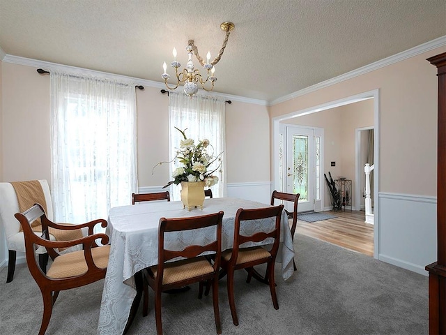 4601 Gann Xing SW, Smyrna, GA 30082 - dining room with a chandelier, crown molding, a textured ceiling, and light colored carpet