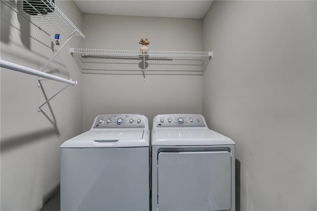 laundry area with washing machine and clothes dryer