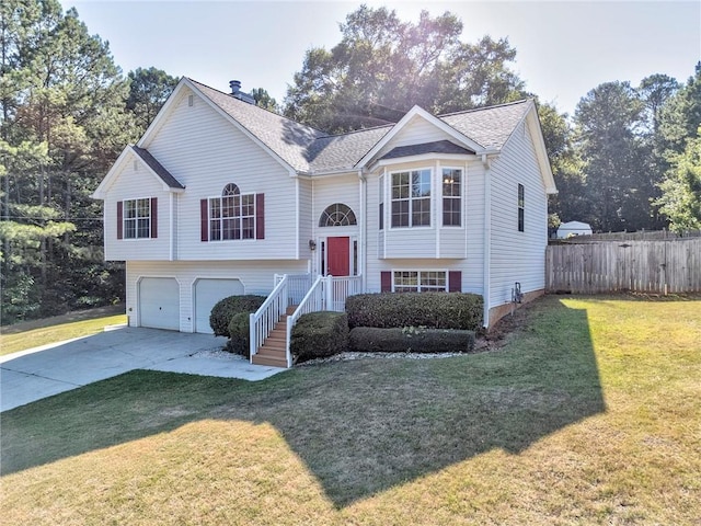 split foyer home with a garage and a front lawn