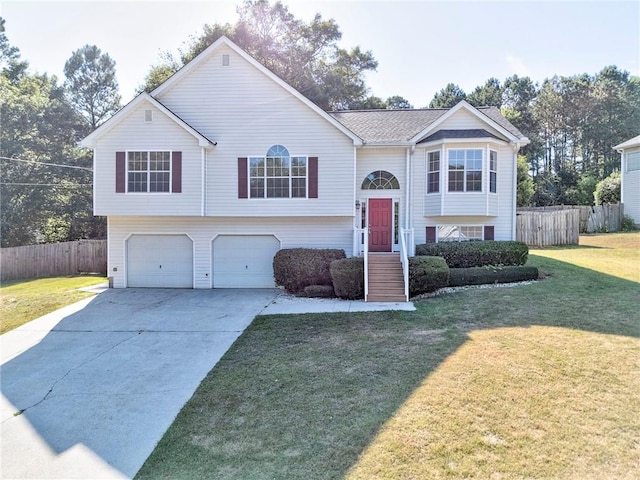 split foyer home with a garage and a front yard