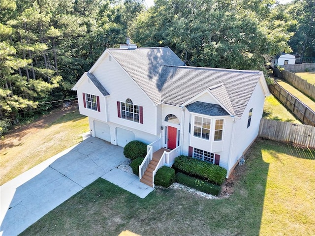 view of front facade with a front yard and a garage